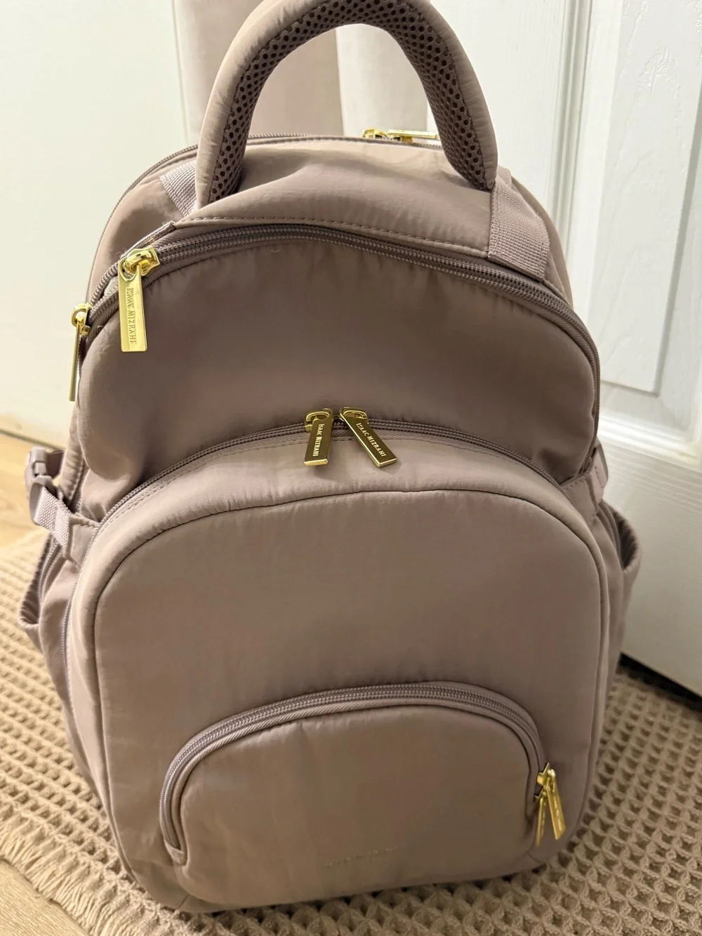 Isaac Mizrahi taupe colored backpack
